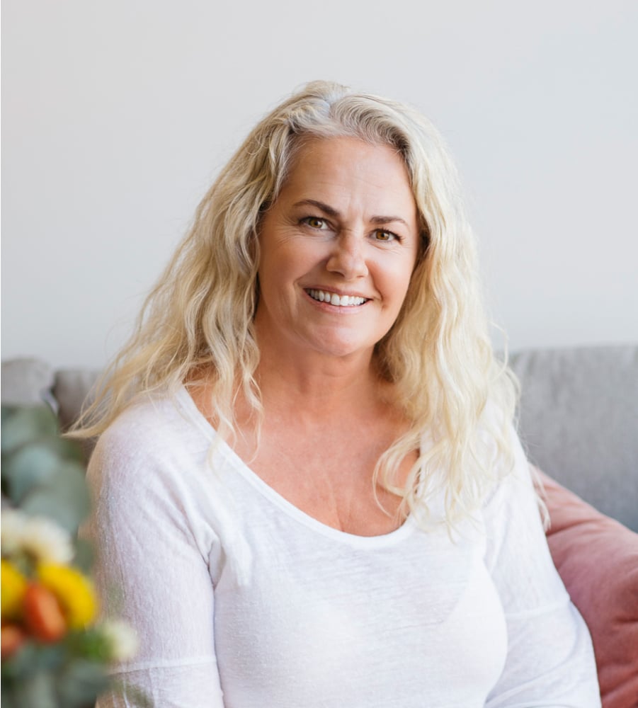 Christy Loupas Smiling wearing a white long sleeve top