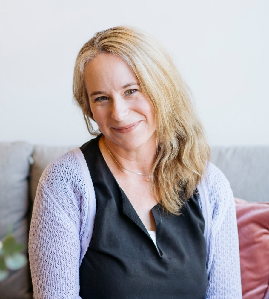 Dr Amber Moore, wearing a purple cardigan and smiling.